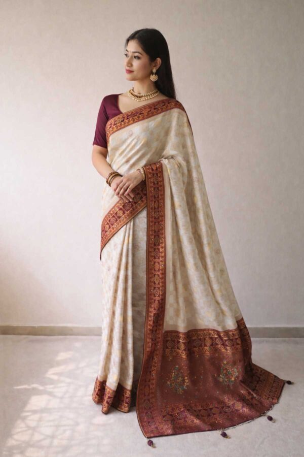 Cream Dola Silk Saree with handwork.